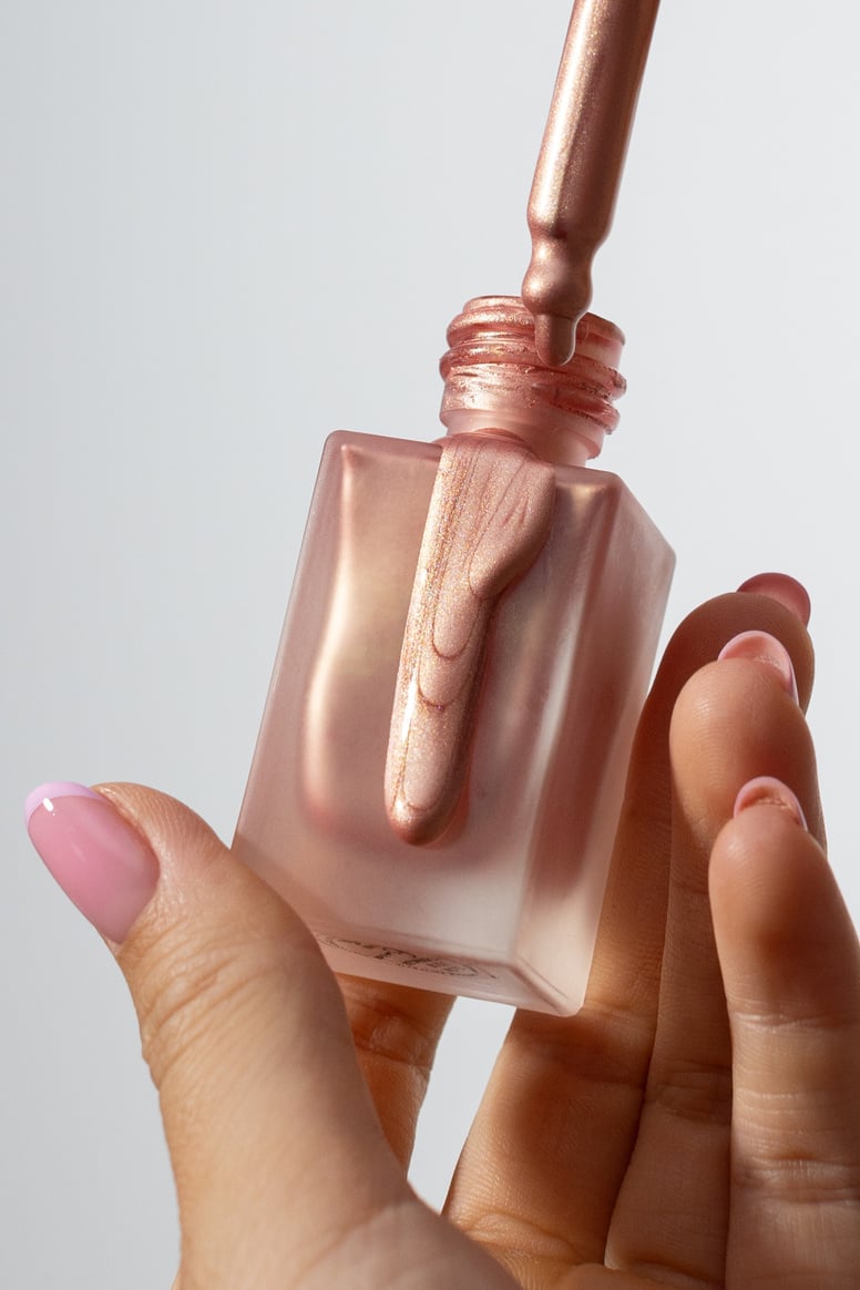 Person's Hands Holding a Bottle of Highlighter