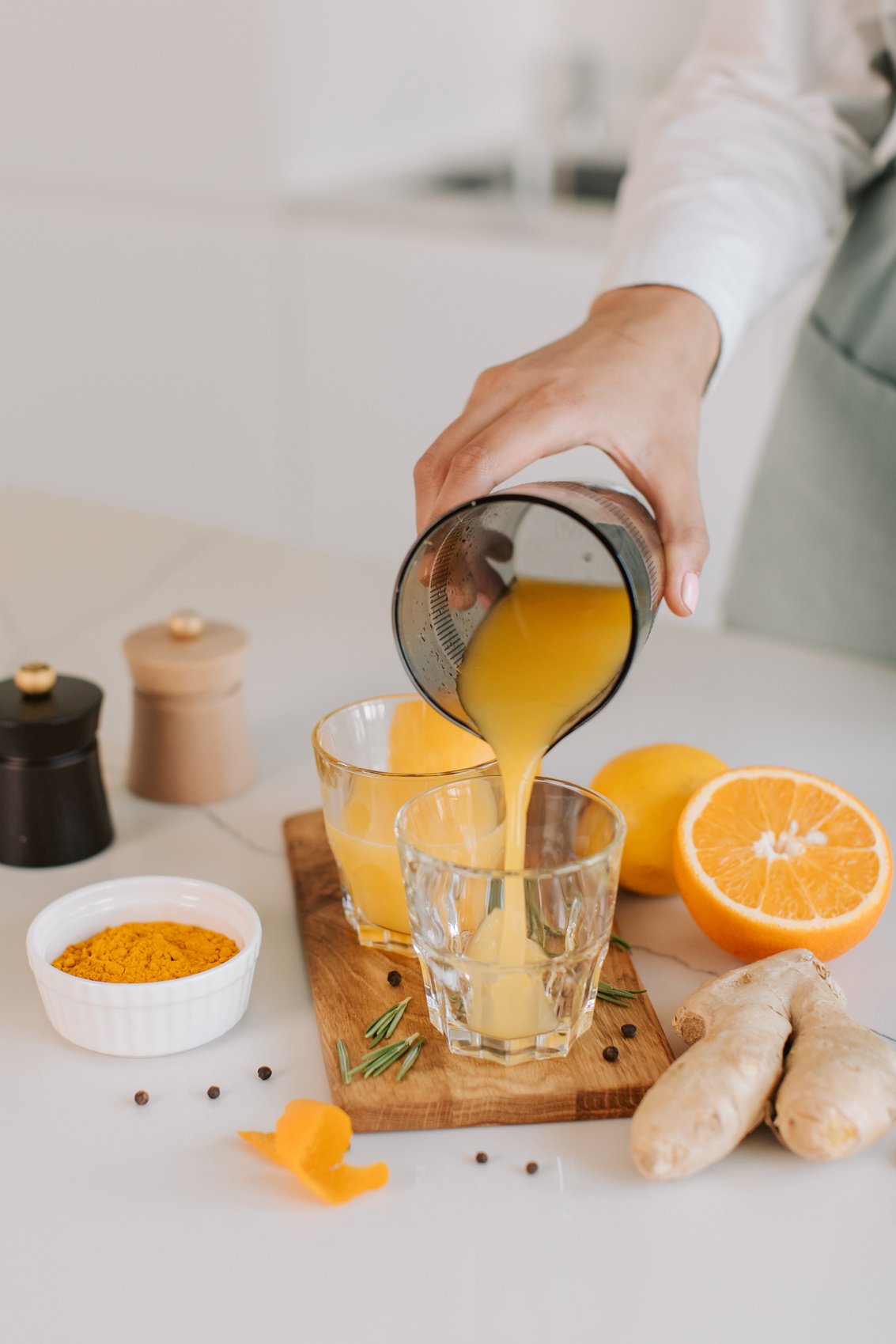 Woman Pouring  Homemade Orange Juice